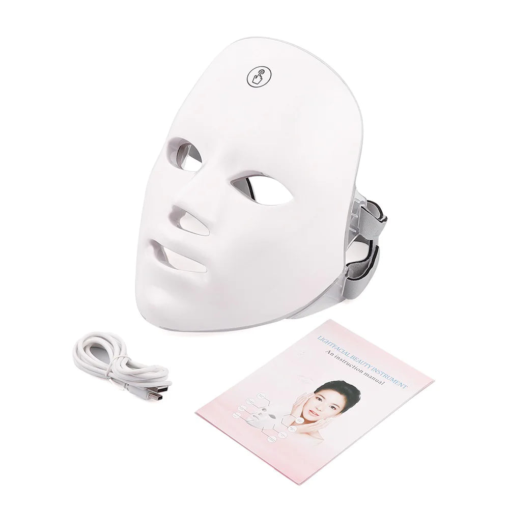 White LED face mask with cable and user manual on a white background