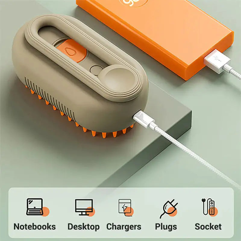 Small electronic device with orange accents being charged on a light green surface.