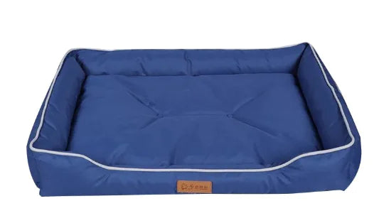 Blue pet bed with white trim on a white background