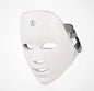 White LED face mask on a light gray background