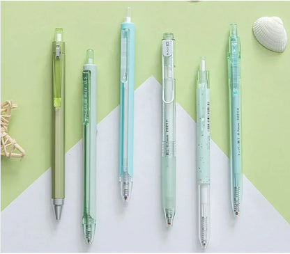 Set of six pens with different colored bodies on a green and white background