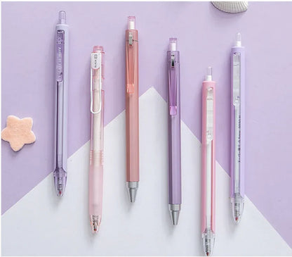 Set of six pens in various pastel colors on a light purple and white background