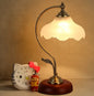 Vintage-style table lamp with a warm glow on a beige background