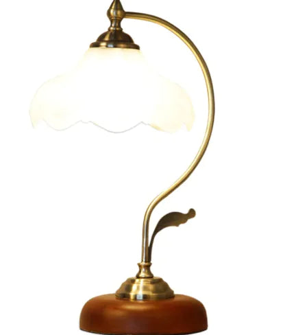 Vintage-style desk lamp with brass and wooden design on a white background